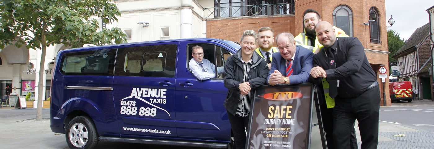 PCC and partners standing in front of a taxi